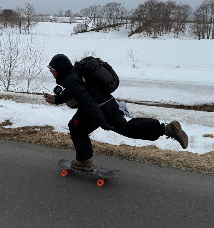 Pushing a loaded board through snow in Japan