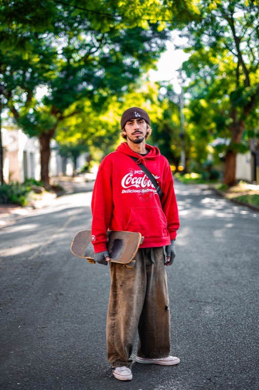 Jason Vanporppal standing in the road with his skateboard